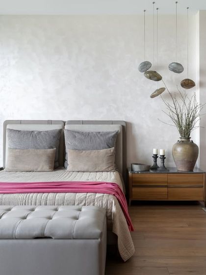 A detail shot of the master bedside, where a custom wooden nightstand is paired with sculptural pendant lights. We believe that even the smallest details contribute to the overall feeling of a room, and this corner is a perfect example of quiet, considered design.