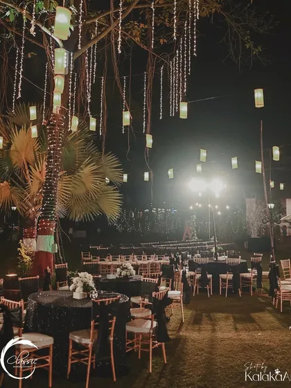 A wider view of the unplugged reception. Hanging lanterns and fairy lights in the trees created a magical, starry-night feel over the entire lawn.