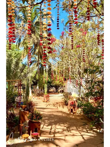 The walkway to the main ceremony area, with colorful flowers hanging from the trees overhead.