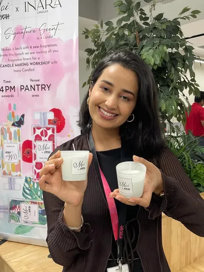 A happy participant at our live candle-making workshop with Nykaa. Guests got to create their own bespoke candles, and the smiles on their faces say it all.
