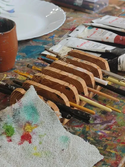 Our studio is filled with the tools of creation. From paint-splattered tables to well-loved brushes waiting in their holders, every corner holds the energy of countless stories and artworks brought to life.