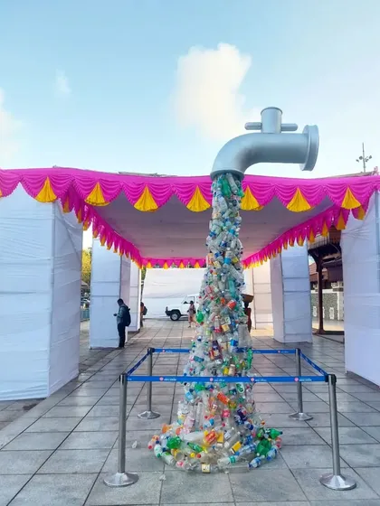 An impactful art installation at Bandra West Railway Station. A giant tap appears to pour out a stream of single-use plastic bottles, creating a powerful message about plastic pollution.