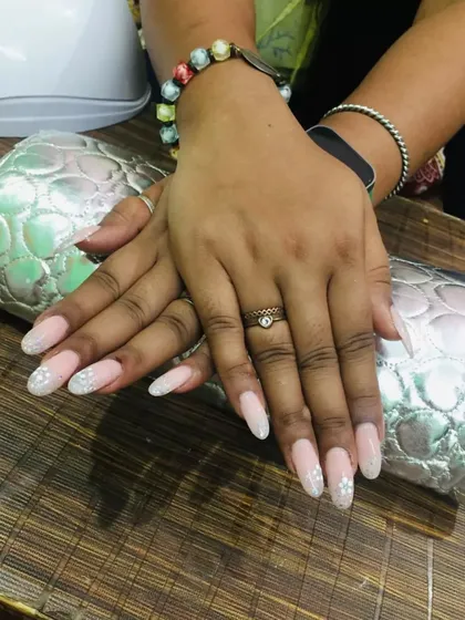 A full view of these gorgeous gel extensions. The soft pink base with scattered glitter is a classic and versatile look that works beautifully for weddings, parties, or even daily wear.