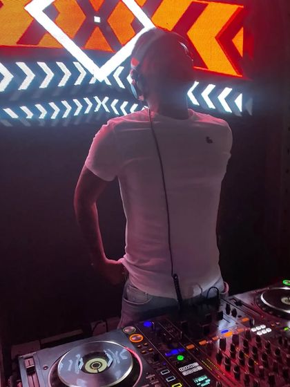 A view from behind the decks, showing my focus on the mixer and the crowd ahead.