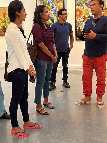 Explaining my art to a group of young visitors at the Colombo exhibition.