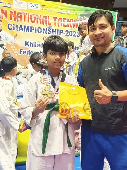 A student with his medal and prize after competing at the national level.