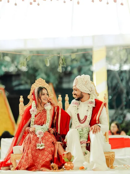 A sweet moment between the couple on the wedding stage, her makeup looking soft and romantic.