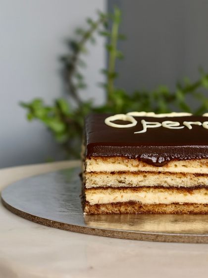 A close-up of the beautiful layers in my Opera Cake. You can see the perfect harmony of coffee, chocolate, and almond sponge, making it a true showstopper.
