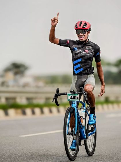 A rider celebrates as he crosses the finish line, a moment of pure joy and relief.