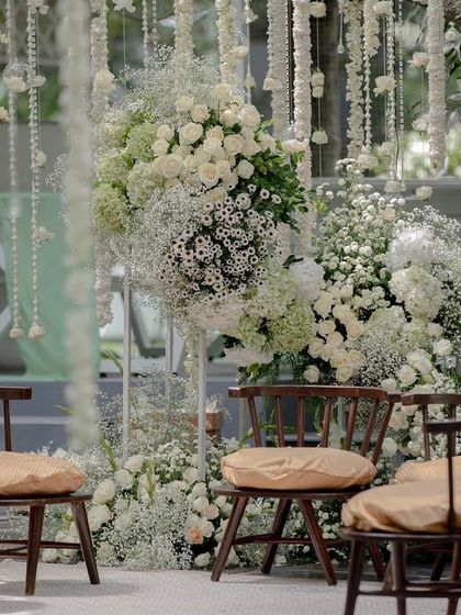 A close-up of the seating area at the all-white wedding, showing the beautiful texture of the floral arrangements.