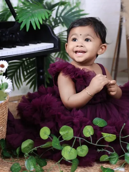 A bright, happy smile from the birthday girl! We focus on capturing genuine expressions of joy during our milestone photoshoots.