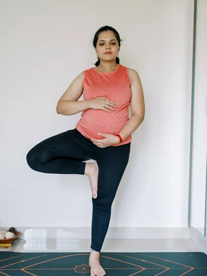 The Tree Pose (Vrikshasana) is a beautiful way to cultivate balance and stability. In this photo from my own pregnancy, I demonstrate how to safely practice this pose, grounding through the standing leg while connecting with my baby.