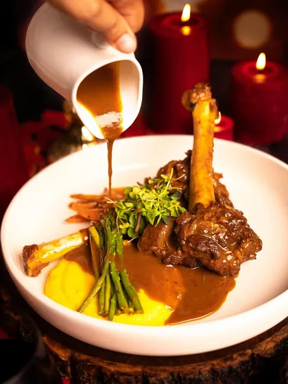 A showstopping Braised Lamb Shank, perfect for a luxurious Christmas dinner. The meat is fall-off-the-bone tender, served with a rich gravy that's full of holiday flavour.