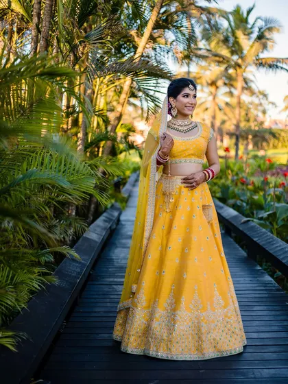 Capturing the essence of a destination wedding in Goa. For this bride, I designed a fresh, sun-kissed look with a bright yellow lehenga that was perfect for the vibrant, tropical setting.