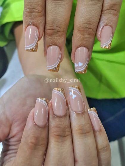 Half French line nails with glitter and two cute little white hearts.