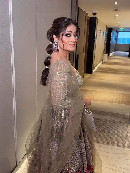 A chic bubble ponytail was the perfect hairstyle for this modern lehenga. The makeup remains flawless from every angle, highlighting her sharp features.