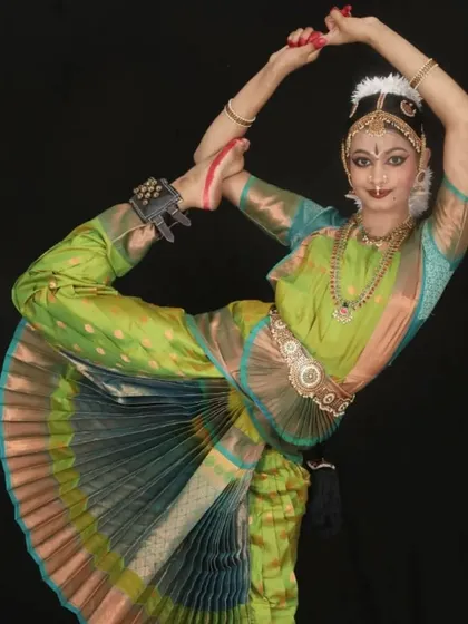 A beautiful pose of Lord Shiva, the cosmic dancer Nataraja, performed by Kriti. Capturing the essence of the deities through dance requires both physical skill and spiritual understanding.