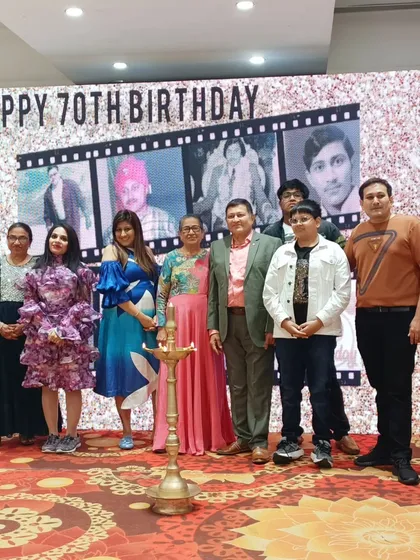 The family of the hour at the 70th birthday celebration. The LED screen behind them displayed a nostalgic photo reel, adding a personal and emotional touch to the event.
