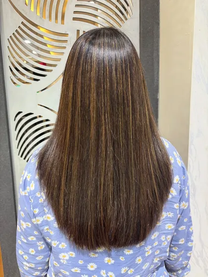 The view from the back shows how beautifully the highlights are distributed through the hair. The Botox treatment provides a perfect, sleek canvas that makes the color pop.