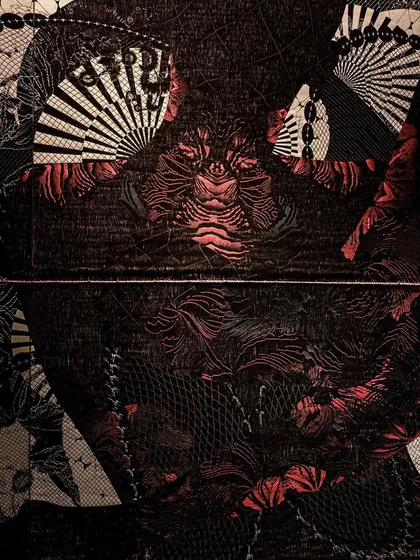 A close-up of the 'Gothilicious' textile, showing the intricate detail of the woven pattern. The design is inspired by the flowing, organic lines of tattoo art.