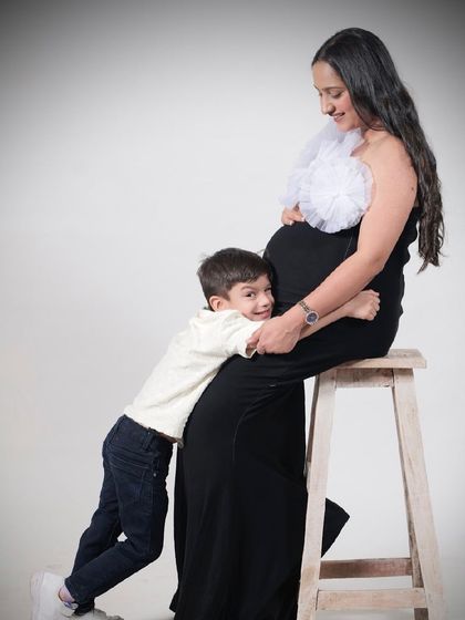 Another adorable shot of a soon-to-be big brother hugging the baby bump. Our comfortable gowns make these sweet, interactive poses easy.