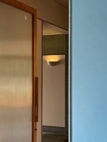 Another glimpse of our collaboration with Malene Bach, showing the interplay of color, light, and material. The soft blue wall creates a moment of calm and coolness within the space.