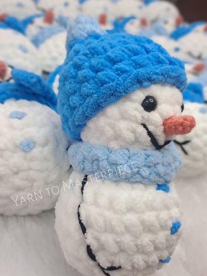 A close-up of a smiling snowman plushie.
