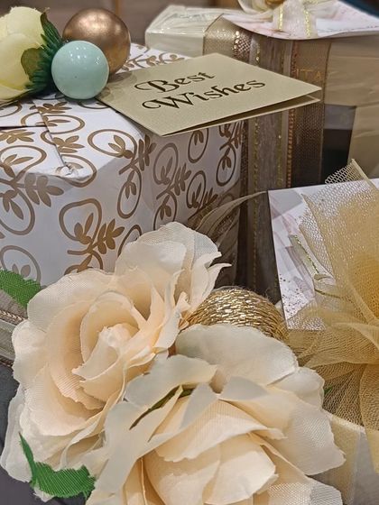 This hamper is all about sending best wishes for a new beginning. The gifts are wrapped in elegant white and gold paper and adorned with soft peach roses, perfect for an engagement or wedding celebration.