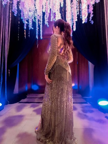 A back view of a stunning golden gown I wore for an anniversary celebration in Thailand. The intricate beading and backless design were pure glamour.