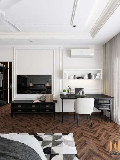 The TV and study area in the modern classic bedroom, featuring black furniture that contrasts sharply with the white moulded walls.