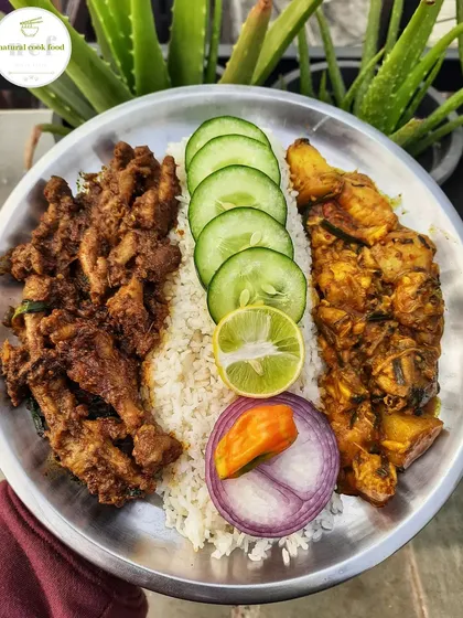 A New Year's special meal with a simple fish curry, chicken feet and liver stir fry, and fresh salad.