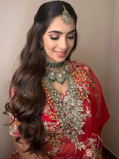 A candid, happy moment. The soft lighting catches the shimmer on her eyelids and the glow on her skin.
