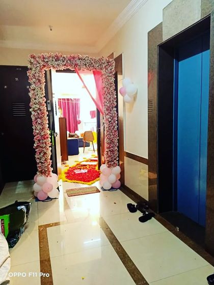 A floral archway at the entrance of the home, creating a grand welcome for the newborn baby and mother.