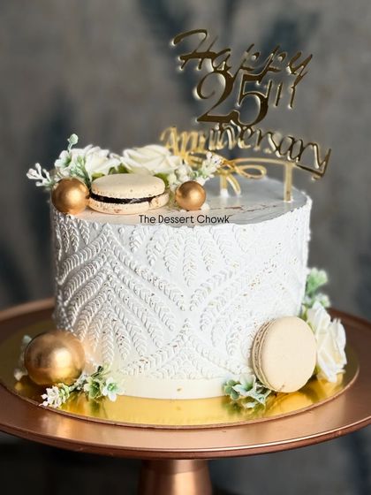 This elegant white tall cake was designed for a 25th anniversary, featuring a delicate stencil pattern on the whipped cream and topped with macarons. The flavor inside is my rich Dutch Chocolate.