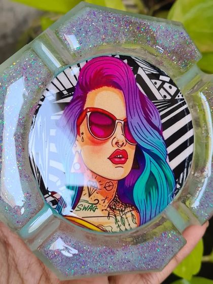 For the funky friend in your life! This custom resin ashtray features a cool, colorful graphic and is surrounded by glitter for that extra bit of sparkle.