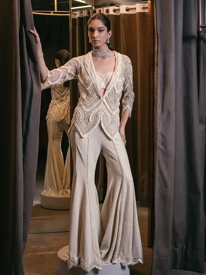 A different angle of the ivory sharara set, showcasing the intricate craftsmanship and impeccable tailoring that celebrates heritage with a contemporary edge.