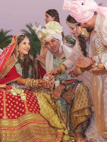 A moment of blessing during the wedding ceremony, a beautiful exchange between the couple and their family.