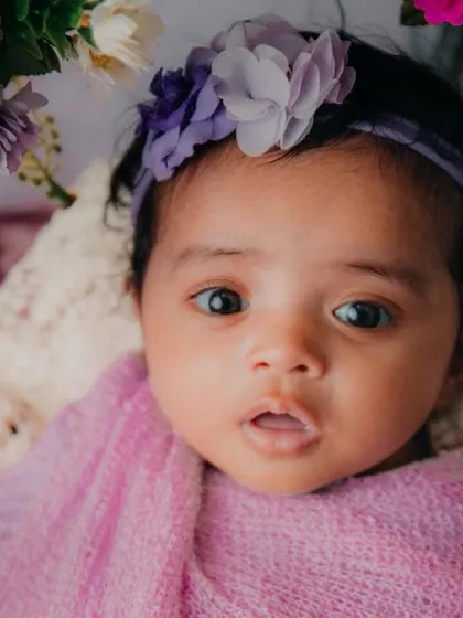 Awestruck by her cuteness. This close-up shot captures the delicate beauty of this 3-month-old baby girl.
