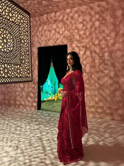 Nysa Devgan looking like a real-life princess in a stunning red saree for a wedding event.