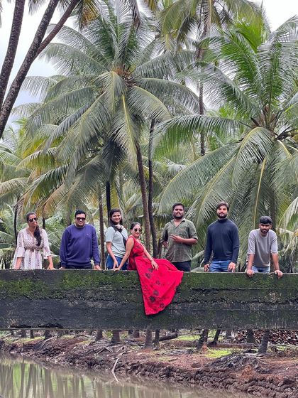 A colorful group photo on a bridge amidst the coconut groves of coastal Karnataka.
