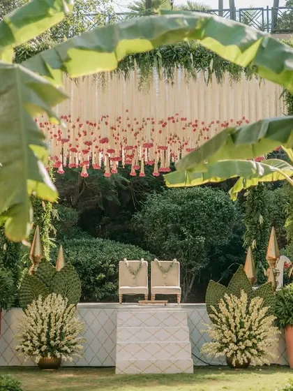 Embracing tradition and sustainability, this mandap uses locally sourced banana plants to create a natural, sacred arch. The backdrop of hanging rajnigandha and rose garlands adds a fragrant, classic touch to this intimate garden wedding ceremony.