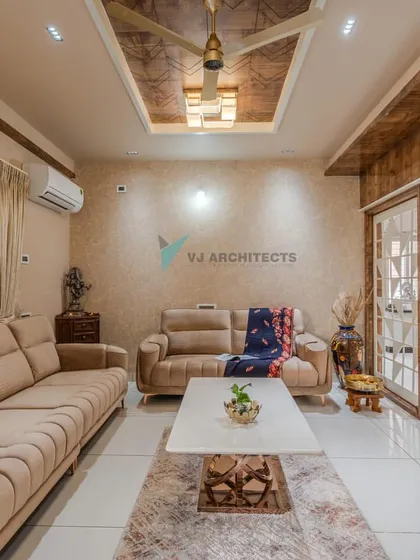 The living room is designed for comfort, with plush sofas and a neutral color scheme. We used a textured wooden ceiling panel and wood-paneled partitions to add warmth and define the open-plan layout.