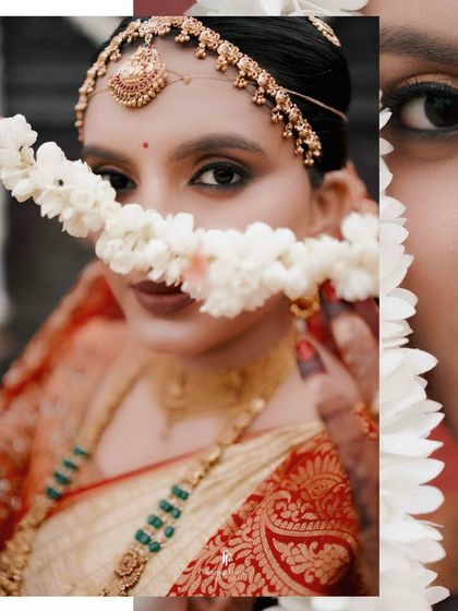 A creative close-up of the bride, peeking through a string of jasmine flowers.