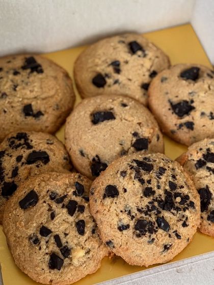 A box of our chunky chocolate chip cookies. Each one is loaded with dark chocolate chunks for a rich and satisfying bite.