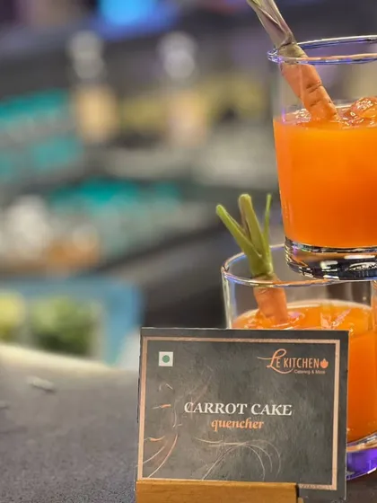 My Carrot Cake Quencher is a unique and healthy beverage option. It captures the flavors of carrot cake in a refreshing, drinkable form, garnished with a baby carrot.
