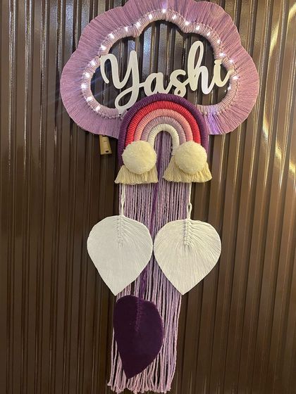 Another view of the 'Yashi' nameplate, showing the soft glow of the fairy lights. The lights are battery-operated and woven into the cloud frame, making them easy to use.