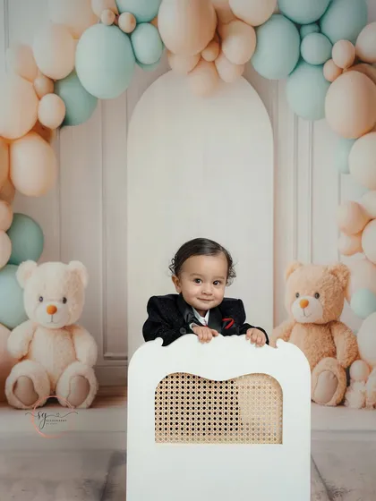 A peek of pure happiness. This candid shot captures a joyful smile during a first birthday session, highlighting the fun and relaxed atmosphere of my studio.