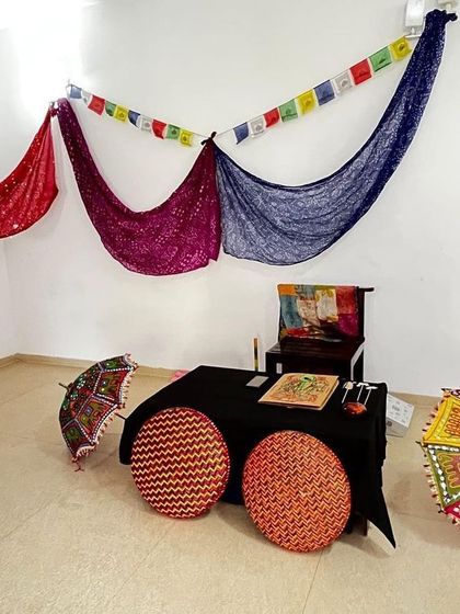 The stage is set for our performance at the 'Houseful' event. We use simple drapes, mats, and colorful props to create an inviting and magical atmosphere for the children.