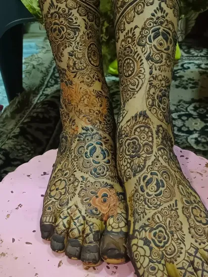A full-coverage design for the feet and ankles, featuring a mix of floral and traditional patterns.