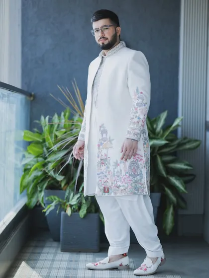 A full-length portrait showcasing the complete wedding day style. From the detailed sherwani to the perfectly styled hair and makeup, my goal is to ensure your entire look is cohesive and impressive.